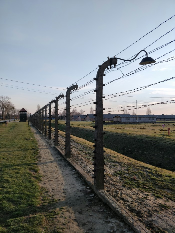 Photo of a barbed wire fence at a Nazi concentration camp during World War II