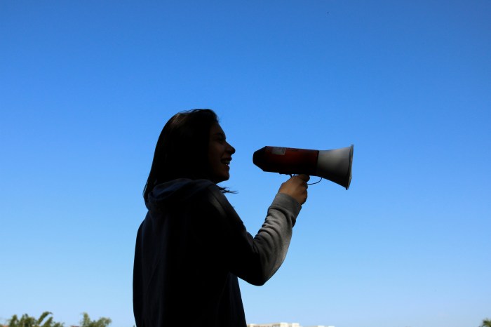 Photo of a woman speaking into a megaphone