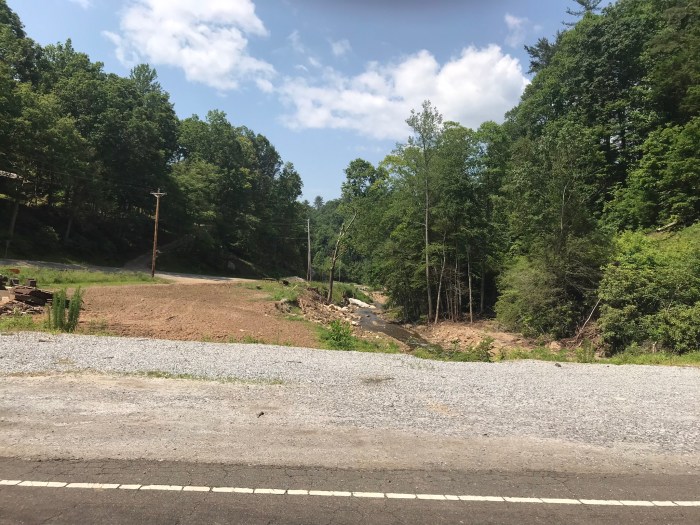 Photo of where a stream flooded area beside the road