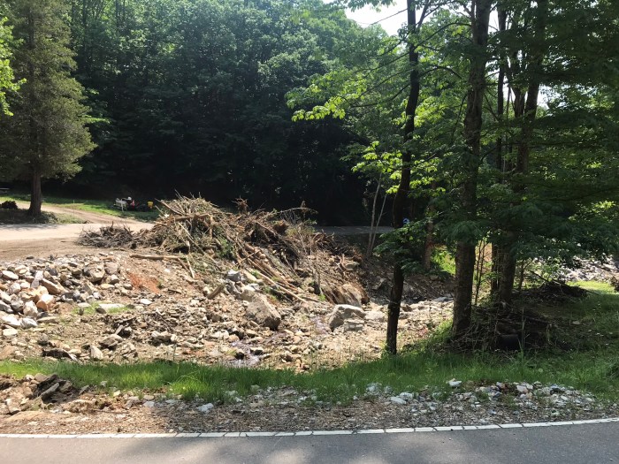 Photo of debris from Hurricane Helene piled beside the highway between Mars Hill and Little Switzerland, NC, June 11, 2025