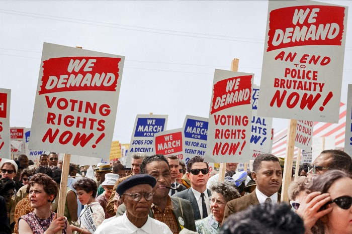Photo of people -- mostly black people -- marching with signs demanding the right to vote.